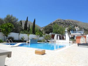 a large swimming pool in front of a house at Villa Elloise in Palermo