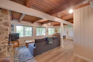 a living room with a couch and a tv at Lakefront Osceola Vacation Rental - Dogs Welcome! in Osceola