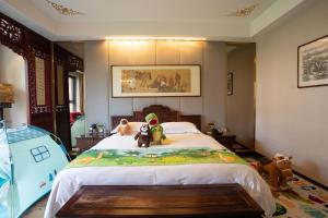 a bedroom with two dogs sitting on a bed at Chengde Imperial Palace Hotel in Chengde