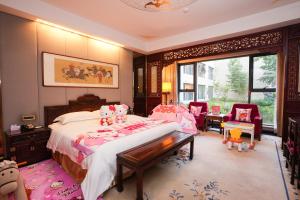 a bedroom with a large bed and a large window at Chengde Imperial Palace Hotel in Chengde