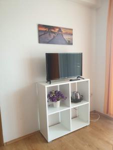 a white cabinet with a television on it at Apartment Perica in Omiš