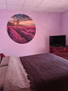 a bedroom with a bed and a flat screen tv at Pension Die kleine Auszeit in Denia