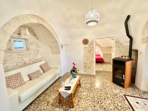 a living room with a couch and a fireplace at Trulli Fenice in Martina Franca