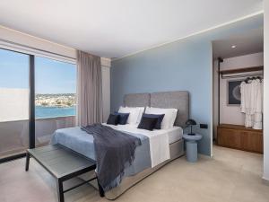 a bedroom with a bed with a view of the ocean at Theta Boutique Hotel in Chania