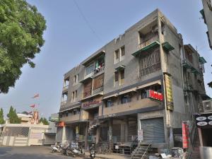 a tall building with people on the balconies of it at Hotel Maninagar Residency in Ahmedabad