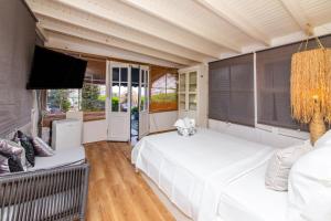 a bedroom with two beds and a flat screen tv at Vacation Flat w Garden Pool in Bodrum Gumusluk in Gumusluk