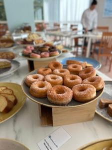 a table with plates of donuts on top at Hotel St Gregory Park in Rimini
