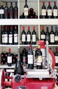 a shelf filled with lots of bottles of wine at Hotel La Pigna in Marina di Pietrasanta