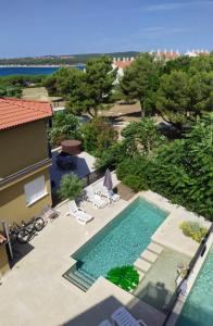 an overhead view of a swimming pool in a resort at V&V Medulin pool and sea in Medulin