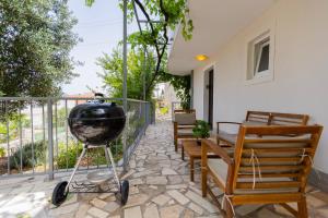 a grill on a stand on a patio at VILLA LEA in Marina