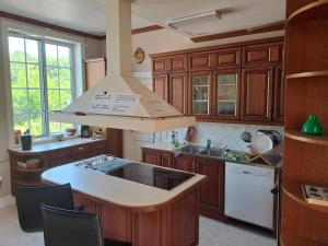 a kitchen with wooden cabinets and a large island at Semester Hem 2 Storvik in Storvik