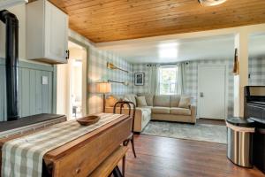 a kitchen and living room with a couch and a table at Eagle River Retreat Near Dam Lake with Boat Dock! in Eagle River