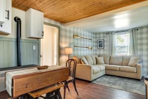 a living room with a couch and a table at Eagle River Retreat Near Dam Lake with Boat Dock! in Eagle River