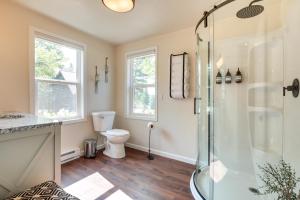 a bathroom with a shower and a toilet at Eagle River Retreat Near Dam Lake with Boat Dock! in Eagle River
