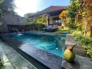 a swimming pool in the backyard of a house at Hidden Point Villa in Ubud