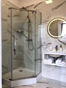 a shower with a glass door in a bathroom at Apartamenty Klifowa 7 in Niechorze