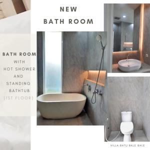 a bathroom with a bath room with a tub and a sink at Vila Batu Bale-Bale in Batu