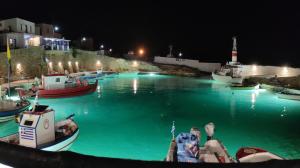 a group of boats in the water at night at Borianoula Apartments in Frý