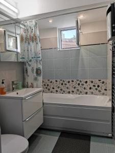 a bathroom with a tub and a toilet and a sink at Miri's House in Eforie Sud +23 photos