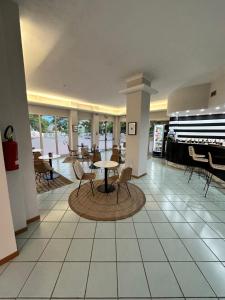 a lobby with a table and chairs in a building at Hotel St Gregory Park in Rimini