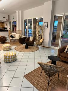 a living room with couches and chairs and tables at Hotel St Gregory Park in Rimini