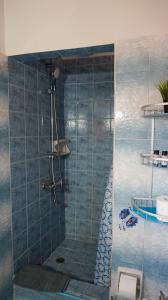 a bathroom with a shower with blue tiles at SOULA ROOMS in Kini +32 photos