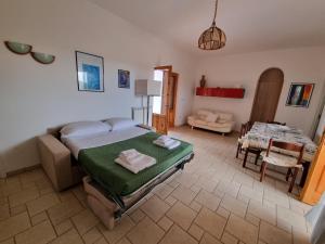 a bedroom with a bed and a living room at Villa Temistocle in Torre Santa Sabina