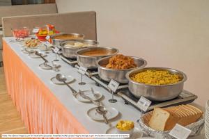 ein Buffet mit Schüsseln voller Speisen auf einem Tisch in der Unterkunft Treebo Premium Arista in Chandīgarh