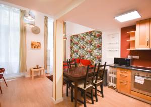 a kitchen and dining room with a table and chairs at Comfortable Apartament on the Boulevard for 4 people in Budapest