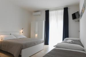 Posteľ alebo postele v izbe v ubytovaní DOMO ALGHERO CENTRO