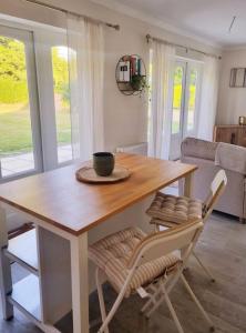 a wooden table and chairs in a living room at Relaxing retreat near Norfolk Broads in Norwich