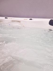 a bath tub filled with lots of water at Relaxing retreat near Norfolk Broads in Norwich