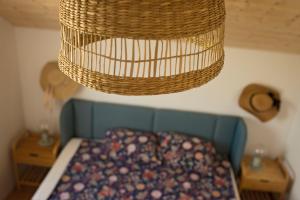 una cesta colgada sobre una cama bajo una lámpara de araña en Sominy House dom na Kaszubach, en Sominy