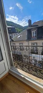 a balcony with a view of a building at Villa Duchatel Appt 2/4 pers in Le Mont-Dore
