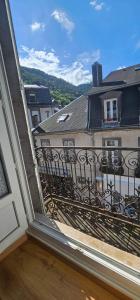 a balcony with a view of a building at Villa Duchatel Appt 2/4 pers in Le Mont-Dore +5 photos