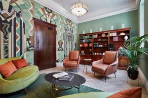 a living room with a couch and two chairs and a table at Brama in Bromley