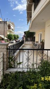 a balcony of a house with a wrought iron fence at Mairi’s Apartment in Nea Artaki