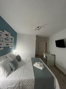 a bedroom with a bed with two towels on it at Casa Vacanze Arcobaleno in Gasponi +3 photos