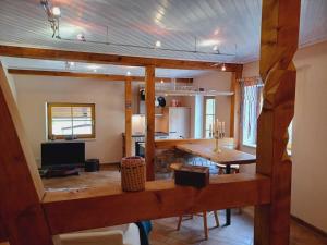 a living room with a table and a kitchen at super cozy holiday apartment in a maritime style in Steinfeld