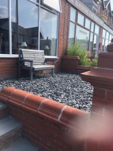 a bench sitting in front of a building with windows at Edenfield Number 42 in Blackpool