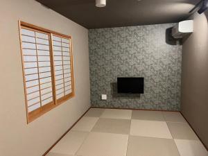Телевизор и/или развлекательный центр в Asagaya House