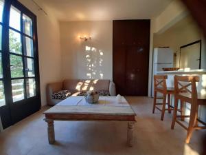 a living room with a table and a couch at Villa Bianca in Kremasti