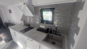 a kitchen counter with a sink and a window at Pids randõ in Kolka +26 photos