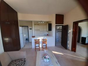een keuken en een woonkamer met een tafel en stoelen bij Villa Bianca in Kremasti