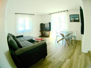 a living room with a couch and a table at B&B - Apartments Sunnwies in Marlengo