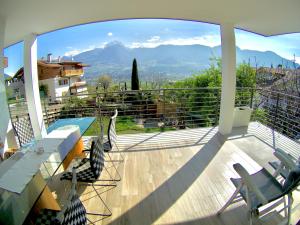 a balcony with chairs and a view of a mountain at B&B - Apartments Sunnwies in Marlengo