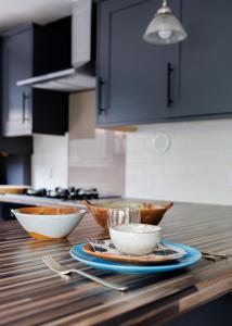 a kitchen counter with bowls and utensils on it at Suburban Hideaway in Suffolk in Ipswich