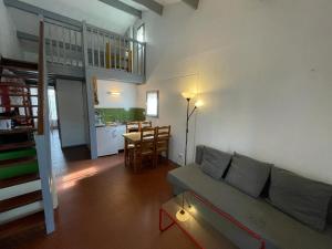 a living room with a couch and a table and a kitchen at Maison Capbreton, 2 pièces, 4 personnes - FR-1-413-100 in Capbreton