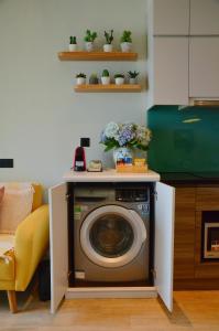 a washing machine in a kitchen with flowers on top at Paradis Homestay Marina Ha Long in Ha Long +27 photos
