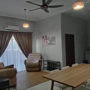 a living room with a table and a chair at Meru Homestay suitable for up to 7 people in Klang